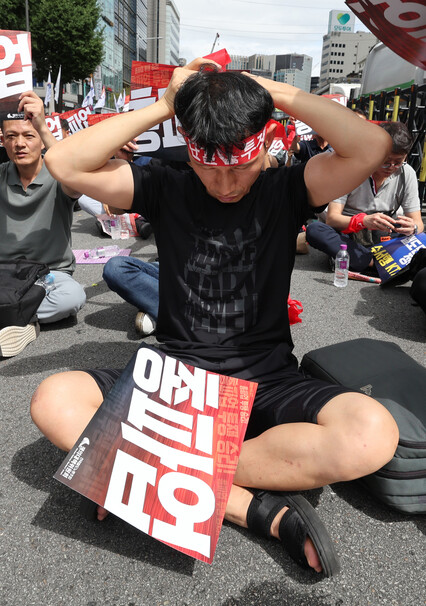 전국철도노동조합이 파업에 돌입한 14일 낮 서울 지하철 1호선 서울역 3번출구 인근 세종대로에서 열린 철도노조 서울지방본부 총파업 출정식에서 참가자가 머리띠를 매고 있다. 신소영 기자 viator@hani.co.kr