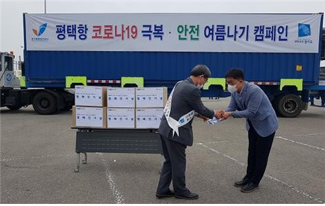경기도와 경기평택항만공사는 18일 평택항에 위치한 컨테이너 터미널 주차장에서 코로나19 극복 및 평택항 홍보 캠페인을 실시했다. 사진은 문학진 사장이 항만근로자에게 기념품을 전달하고 있다. 경기도와 경기평택항만공사는 18일 평택항에 위치한 컨테이너 터미널 주차장에서 코로나19 극복 및 평택항 홍보 캠페인을 실시했다. 사진은 문학진 사장이 항만근로자에게 기념품을 전달하고 있다.