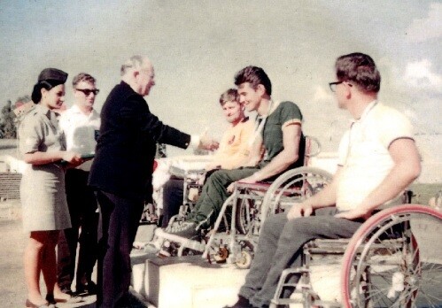 루드비히 구트만 박사가 1968년 텔아비브 하계 패럴림픽에서 호주 양궁 선수 토니 사우스에게 금메달을 수여하는 모습. 출처: 위키미디어 커먼스