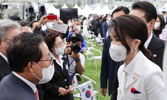 김건희 여사가 지난 15일 서울 용산 대통령실 청사 잔디마당에서 열린 제77주년 광복절 경축식이 끝난 뒤 윤석열 대통령에 이어 참석자들과 인사하고 있다. 연합뉴스