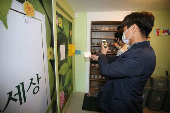 12일 대구시 중구의 폐쇄된 한 신천지 교육 시설에서 중구청과 대구시설공단 관계자들이 사람들의 출입 여부를 점검하고 있다. 연합뉴스