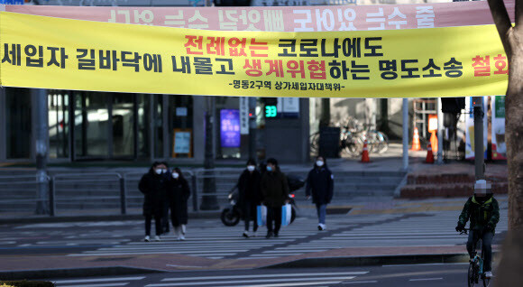 15일 오후 서울 명동 입구에 상가 세입자들이 생존권 보장을 요구하는 펼침막을 내걸었다. 연합뉴스