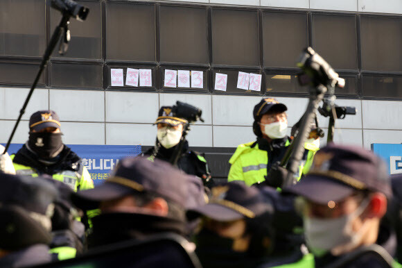 전국민주노동조합총연맹(민주노총) 조합원들이 26일 오전 ''노란봉투법''으로 불리는 노조법(노동조합 및 노동관계조정법) 2·3조 개정을 요구하던 중 입구 앞에서 경찰과 대치하고 있다. 연합뉴스