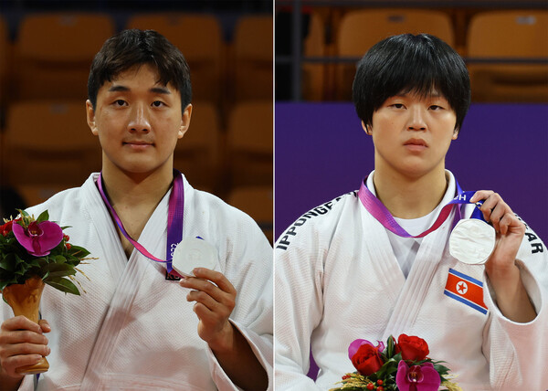 25일 저녁 중국 항저우 샤오산 린푸 체육관에서 열린 항저우아시안게임 유도 시상식에서 이준환(왼쪽)과 북한의 문성희가 은메달을 목에 걸고 있다. 항저우/윤운식 선임기자 yws@hani.co.kr