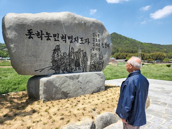 지난 5월 5일 전남 무안군 몽탄면 다산리 차뫼마을 입구에 세워진 동학농민혁명지도자 김응문 일가의 현창비를 후손 김성황씨가 살펴보고 있다. 김용희 기자