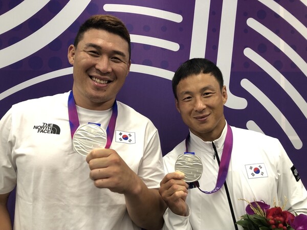 한국 럭비의 간판 박완용(오른쪽)과 한건규가 26일 항저우아시안게임에서 은메달을 목에 건 뒤 포즈를 취하고 있다.