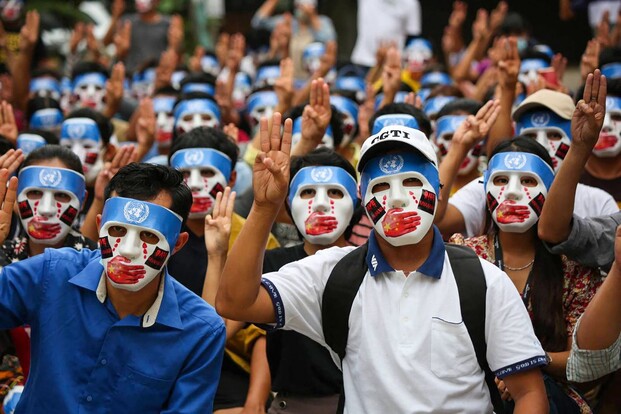 4일(현지시각) 미얀마 양곤에서 쿠데타에 반대하는 시민들이 중국의 유엔 개입 방해를 비판하는 가면을 쓰고 세 손가락 경례를 하고 있다. 양곤/AFP 연합뉴스