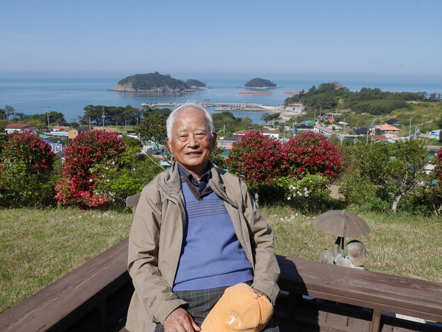 전남 완도 보길도 선창리 자택의 김민환 교수 뒤로 섬과 바다가 펼쳐져 있다. 조현 기자