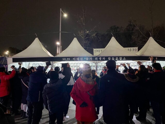 1일 서울 용산구 이태원 광장에 차려진 시민분향소에 모인 이태원 참사 유가족 50여명이 0시에 맞춰 희생자들의 이름이 띄운 휴대전화를 하늘로 들어 올린 채 희생자들의 이름을 부르고 있다. 10.29 이태원 참사 시민대책회의 제공