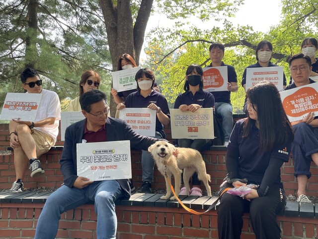 19일 오전 서울 여의도 국회도서관 야외음악당에서 열린 ‘개농장 구조견과 함께하는 산책, 꽃길’ 행사에서 국민의힘 이헌승 의원(가운데)이 개농장 구조견 ‘별빛이’를 쓰다듬고 있다. 이날 행사에는 구조견 4마리와 동물단체 활동가, 시민, 국회의원 등 40여 명이 참석했다. 김지숙 기자 suoop@hani.co.kr