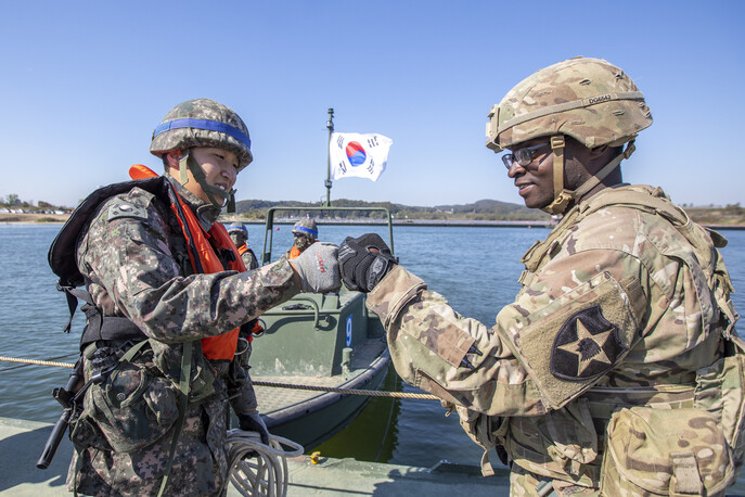 19일 경기도 여주시 남한강 일대에서 호국훈련 일환으로 열린 한미연합 제병협동 도하훈련에 참가한 한미 장병들이 주먹인사를 하고 있다. 육군 제공