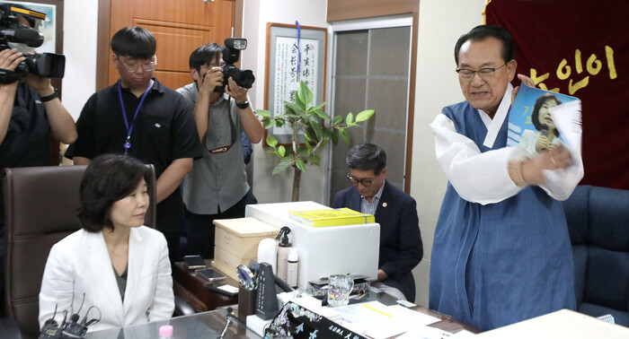 김호일 대한노인회 회장이 3일 서울 용산 대한노인회 중앙회에서 노인폄하 발언 사과를 위해 방문한 더불어민주당 김은경 혁신위원장과 면담 중 위원장의 뺨 대신 사진을 때리고 있다. 공동취재사진