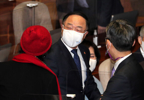 홍남기 경제부총리가 3일 국회 본회의장에서 열린민주당 김진애 의원(왼쪽)과 대화하고 있다. 연합뉴스