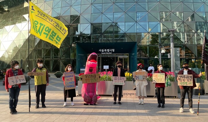 청년기후긴급행동 활동가들과 이 단체의 마스코트 김공룡이 9일 오후 5시 서울시청 앞 광장에서 기자회견을 열고 오세훈 시장의 기후위기 대응을 촉구했다.