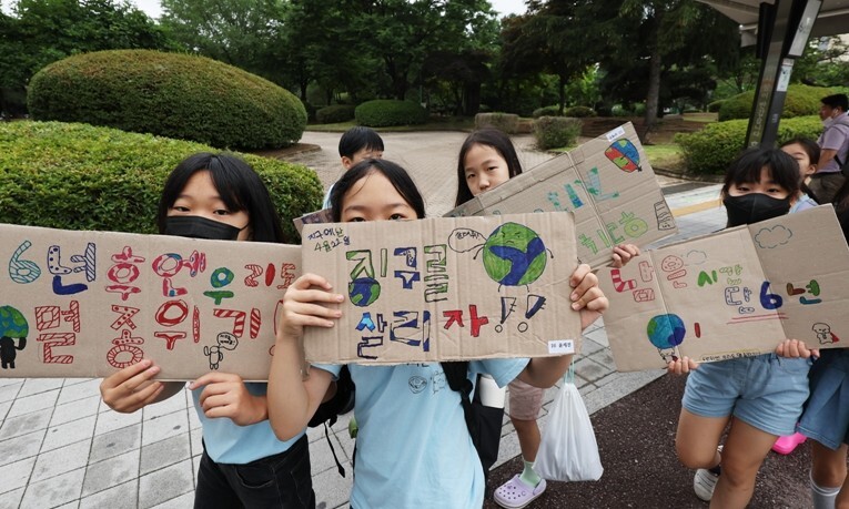 5일 경기도 수원시청에서 신영초등학교 학생들이 수원민주시민교육협의회 빛길, 수원환경운동연합, 수원KYC, 인권교육 온다 등과 함께 기후위기 극복 캠페인을 하며 구호를 외치고 있다. 연합뉴스