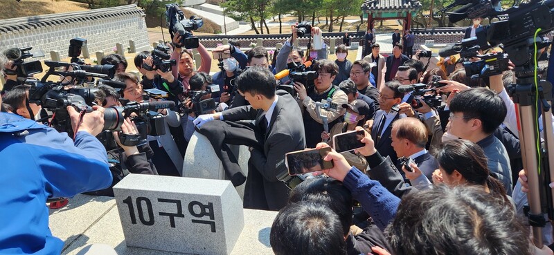 고 전두환씨의 손자 우원씨가 31일 광주 국립5·18민주묘지를 방문해 행방불명자 묘역 안내석을 입고 있던 검정색 외투를 벗어 닦으며 희생자를 추모하고 있다.김용희 기자 kimyh@hani.co.kr