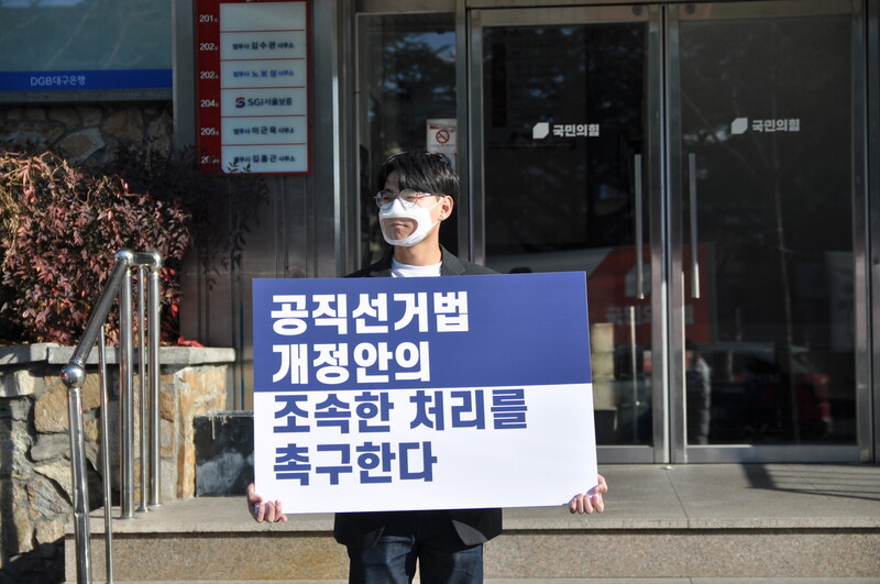 지난해 12월 피선거권 연령을 ‘만 18살’로 하향하는 공직선거법 개정안이 통과되기 전 국민의힘 대구시당 앞에서 1인시위를 진행한 강사빈(20) 전 청년나우 발행인. 강사빈 제공