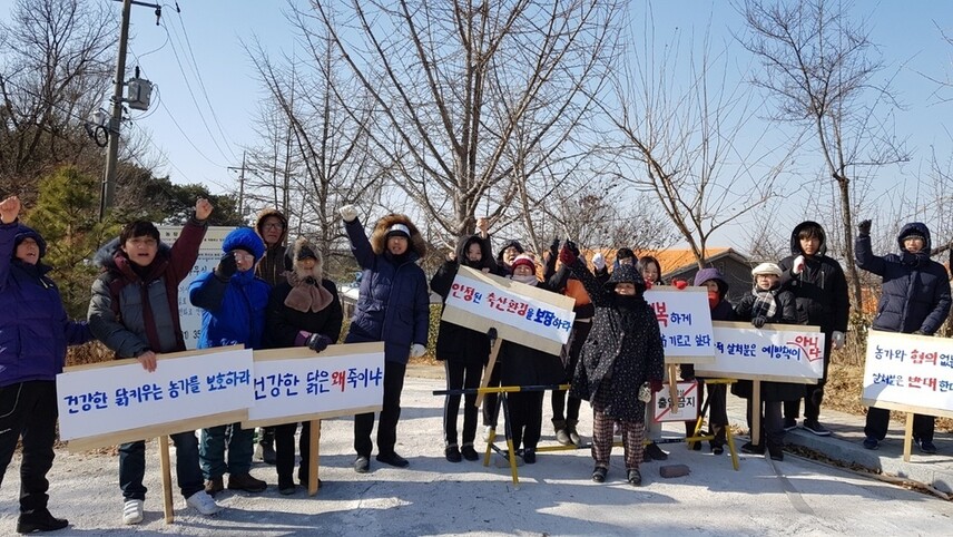 2018년 12월29일 경기도의 예방적 살처분에 항의해 무소유 마을로 알려진 화성시 향남읍 산안마을 주민들이 농장 입구에서 관행적인 예방적 살처분 반대 시위를 하고 있다.