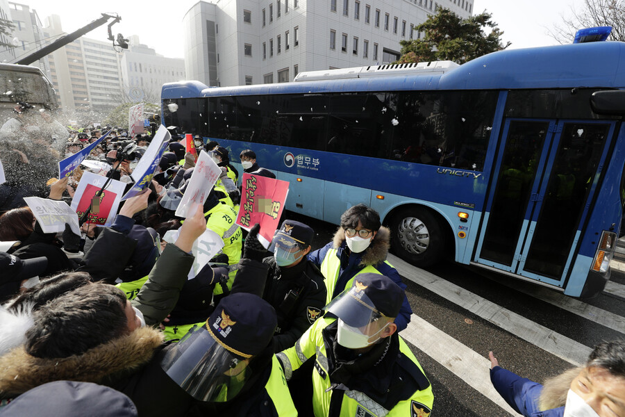 16개월 된 입양 딸 정인이를 학대해 숨지게 한 혐의를 받는 양부모의 첫 재판이 열린 13일 서울 양천구 서울남부지법에서 양모가 탄 호송차가 법원을 빠져나가자 시민들이 항의하고 있다. 김명진 기자 littleprince@hani.co.kr