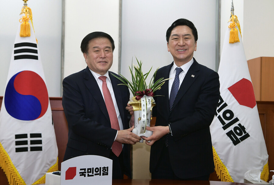 김기현 국민의힘 대표(오른쪽)가 9일 국회 국민의힘 당 대표실에서 이진복 대통령실 정무수석비서관을 만나 대통령이 보낸 축하 난을 받고 있다. 공동취재사진