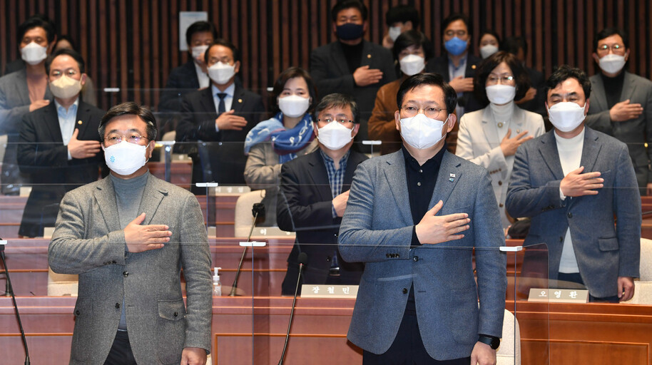 더불어민주당 송영길 상임선대위원장과 윤호중 공동선대위원장이 21일 오후 국회에서 열린 긴급 의원총회에서 의원들과 국기에 경례하고 있다. 국회사진기자단