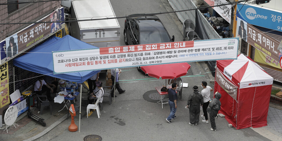 사랑제일교회 연관 코로나 19 확진자가 20일 정오까지 누적 676명을 기록한 가운데 서울 성북구 사랑제일교회 앞에서 방역 담당자들이 교회 관계자와 이야기를 하고 있다. 김혜윤 기자 unique@hani.co.kr