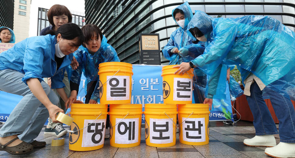 서울여성연대(준) 등 여성단체 회원들이 21일 오전 서울 종로구 주한일본대사관 앞에서 일본의 후쿠시마 방사성 오염수 해양 투기를 비판하며 핵폐기물 저장용기를 뜻하는 플라스틱 통을 이용해 ‘일본 땅에 보관이’라는 문구를 만들고 있다. 김정효 기자 hyopd@hani.co.kr