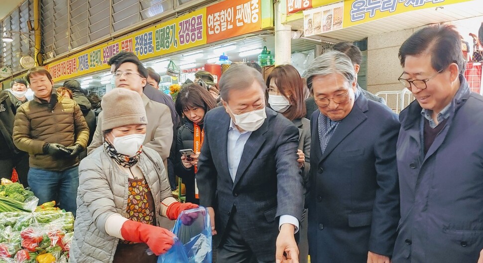 문재인 대통령이 9일 오후 충남 아산의 온양온천전통시장을 전격 방문해 물건을 사고 상인들을 격려하고 있다. 충남도 제공