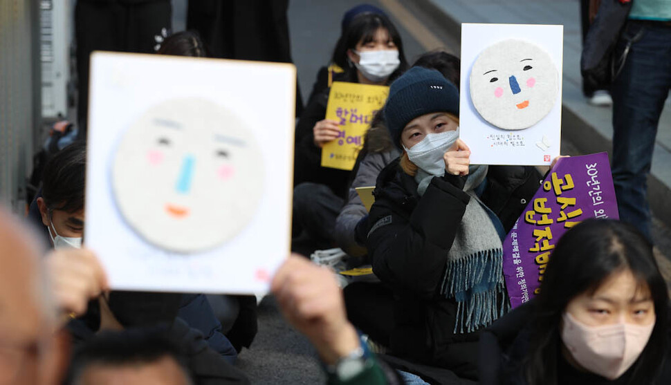 제1573차 정기 수요시위 참가자들이 7일 오후 서울 종로구 옛 일본대사관 인근에서 연대발언에 나선 윤청자 5월민주여성회 회장이 준비해 와 나눠준 연대 선물을 들고 있다. 김정효 기자