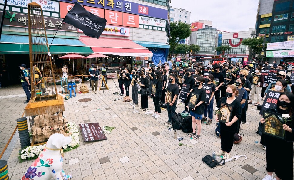 말복인 15일 경기 성남시 모란시장 앞에서 동물해방물결 활동가와 시민들이 ‘2022 복날 추모행동’ 기자회견을 열고 건강원 앞 거리에 설치된 ‘복날 추모탑’에 추모의 메시지를 걸고 있다. 동물해방물결 제공