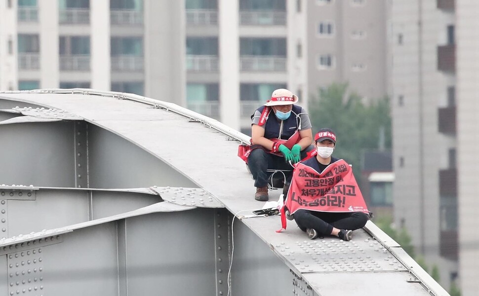 엘지(LG)헬로비전 비정규직지부 이희민 조합원(앞)과 유희원 사무국장(뒤)이 12일 오후 서울 한강대교위에서 고공농성을 하고 있다. 백소아 기자