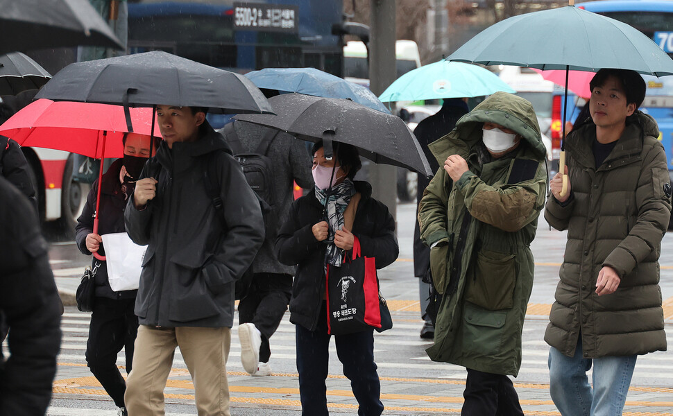 전국적으로 비가 오고 흐린 날씨를 보인 11일 오전 서울 광화문네거리에서 시민들이 우산을 쓰고 건널목을 건너고 있다. 신소영 기자 viator@hani.co.kr