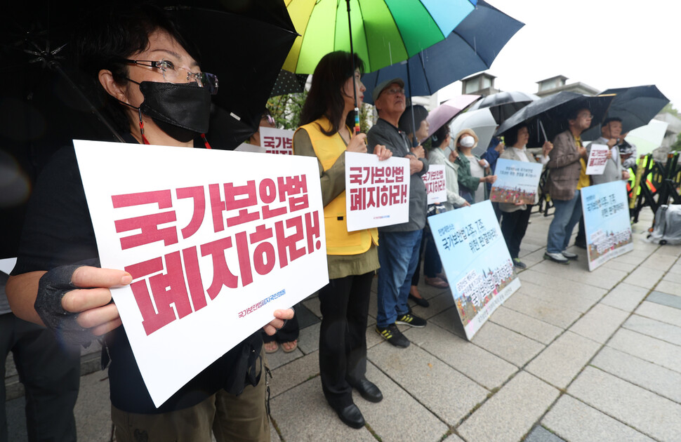 국가보안법폐지국민행동이 26일 오후 서울 종로구 헌법재판소 앞에서 연 국가보안법 2·7조 위헌심판 결정에 대한 입장발표 기자회견에서 참가자들이 손팻말을 들고 있다. 연합뉴스