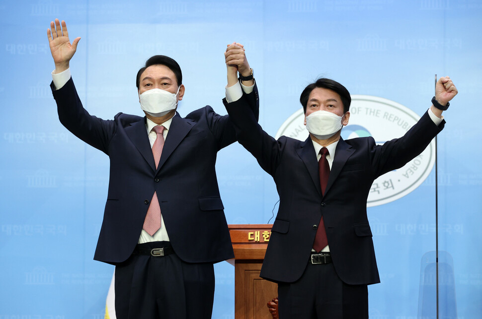 윤석열 국민의힘 대선 후보와 안철수 국민의당 대선 후보가 3일 오전 서울 여의도 국회 소통관에서 단일화 기자회견을 마치고 손을 맞잡고 있다. 공동취재사진