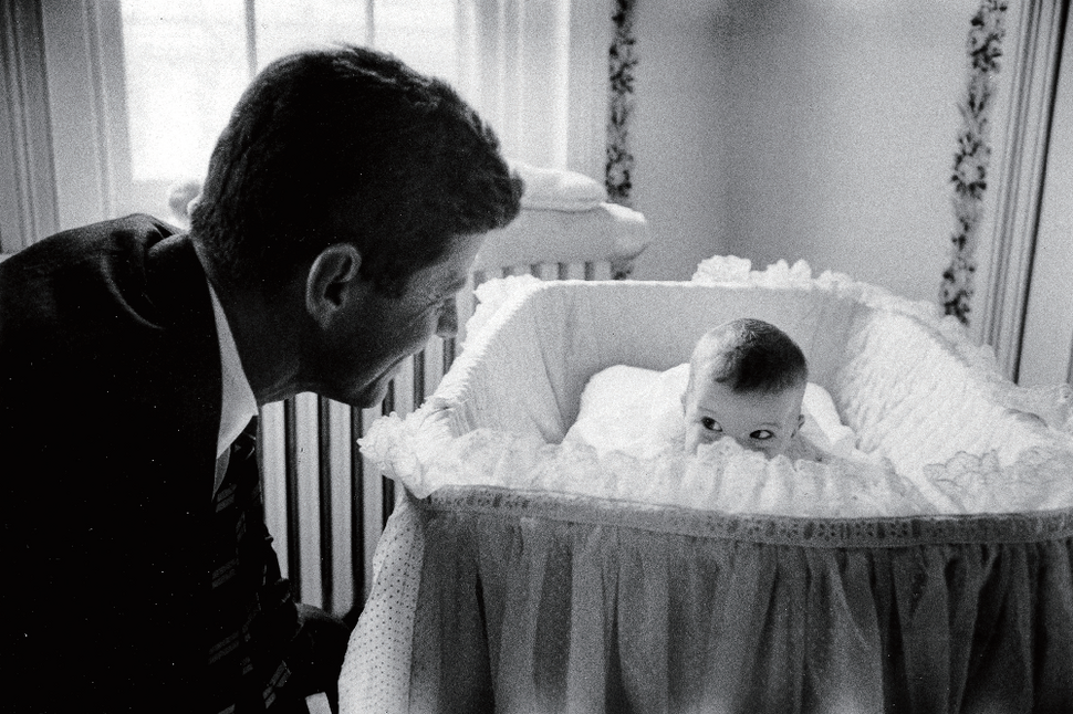 Sen. John F. Kennedy (L) playing peek-a-boo with his daughter Caroline in her crib. 1958. Photo by Ed Clark ⓒThe LIFE Picture Collection