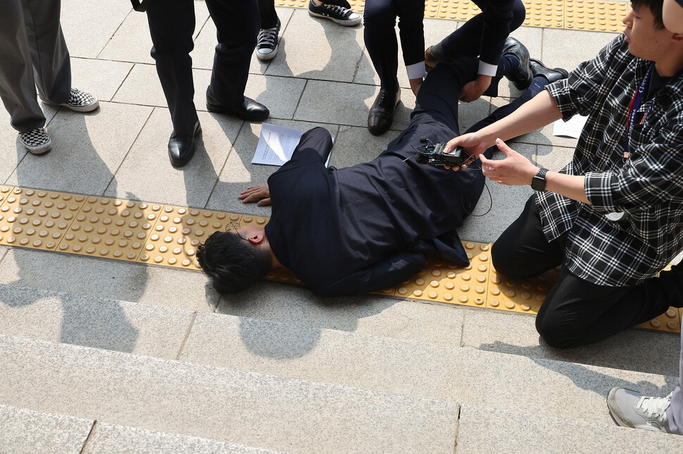 장경태 더불어민주당 최고위원이 14일 경기 정부과천청사 방송통신위원회 건물 앞에서 조승래 더불어민주당 의원과 방통위 일방적 운영방식 및 김효재 상임위원의 위법 등의 행위에 항의 방문하다 쓰러져 있다. 김혜윤 기자 unique@hani.co.kr