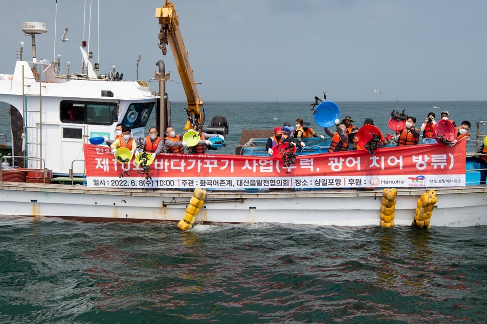 충남 서산 삼길포 연안에서 지난해 화곡어촌계·대산읍발전협의회·한화토탈에너지스 등이 조피볼락(우럭)과 광어 치어를 방류하고 있다. 한화토탈에너지스 제공