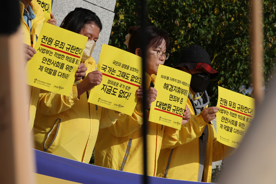 노란 외투를 입은 4.16세월호참사가족협의회 유가족들이 사법부 판결을 규탄하는 손팻말을 들고 있다. 김혜윤 기자