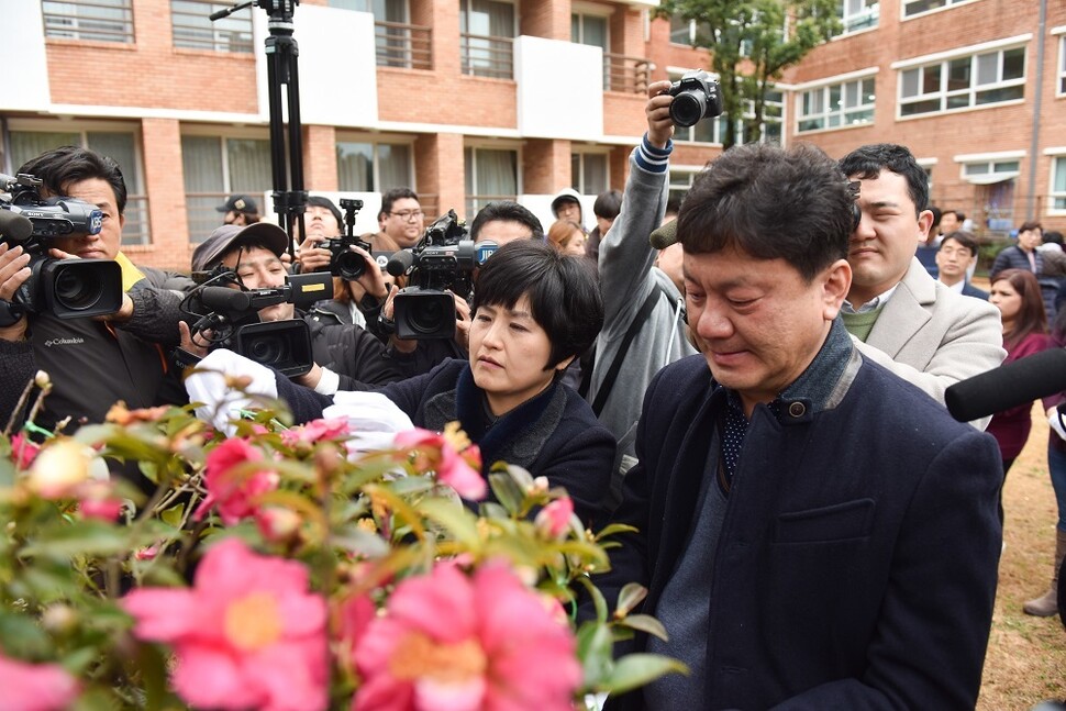 6명의 이름 모를 이들에게 새 생명을 주고 떠난 고 김유나 양의 부모가 딸을 기리를 동백나무를 바라보고 있다. 사랑의장기기증운동본부 제공