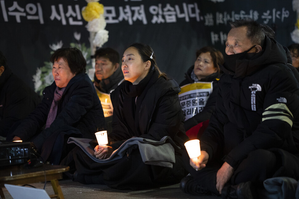 오은주씨와 가족들이 시민분향소 앞에서 열린 문화제에서 촛불을 들고 있다.