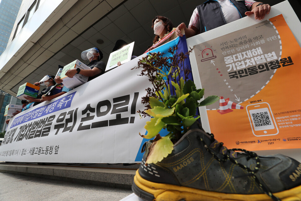 `비정규직 이제그만! 1100만 비정규직 공동투쟁' 주최로 10일 서울 중구 서울고용노동청 앞에서 열린 `중대재해기업처벌법 제정 및 국민동의 청원 비정규직 노동자 동참 호소 기자회견'에서 일하다 숨진 산재노동자를 추모하는 의미로 작업화에서 자라는 꽃이 놓여 있다. 강창광 선임기자 chang@hani.co.kr