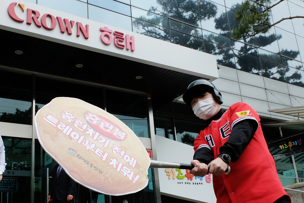 29일 서울 용산구 남영동 해태제과 본사 앞에서 해태 유니폼을 입은 환경운동연합 활동가가 홈런볼 등 과자에 들어있는 플라스틱 트레이를 없애라는 퍼포먼스를 하고 있다. 환경운동연합 제공