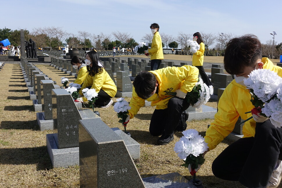 제주지역 4개 대학 총학생회와 제주4·3평화재단이 운영하는 대학생 자원봉사단체인 ‘동백서포터즈’가 합동으로 지난달 27일 제주4·3평화공원 내 행방불명인 표석 구역에서 4·3추념일을 앞두고 표석을 정비하고 조화를 꽂고 있다. 허호준 기자