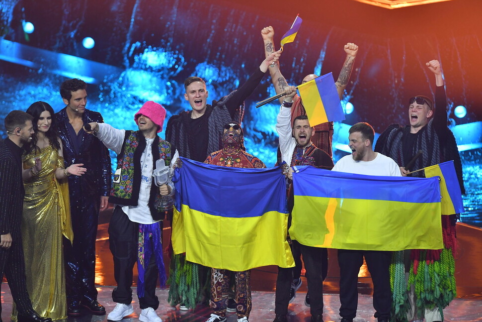 우크라이나 밴드 ‘칼루시 오케스트라’가 지난 14일(현지시각) 이탈리아 북서부 토리노에서 열린 유럽 최대 팝 음악 축제 ‘유로비전 송 2022’에서 대상을 수상한 뒤 국기를 펼쳐든 채 기뻐하고 있다. 토리노/EPA 연합뉴스