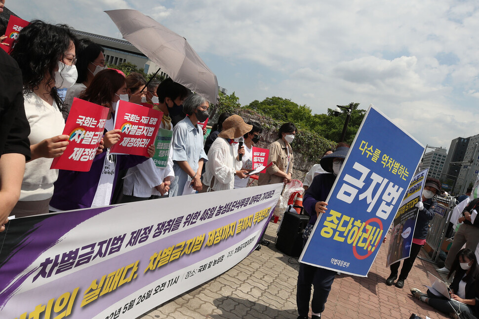 차별금지법 제정을 요구하는 단식농성 46일째인 26일 서울 여의도 국회의사당 앞에서 열린 농성&amp;단식투쟁 마무리 기자회견에서 차별금지법제정을 반대하는 시민들이 대형팻말을 들고 지나가고 있다. 백소아 기자