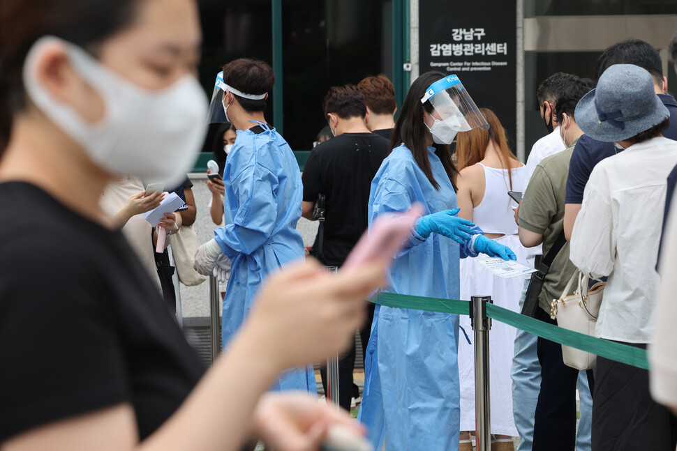 코로나19 신규 확진자가 10만명을 넘어선 27일 오전 서울 강남구보건소 선별진료소에서 의료진들이 분주히 움직이고 있다. 연합뉴스