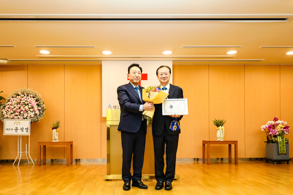 8월 17일(목), 서울 중구 대한적십자사 서울사무소 4층 앙리뒤낭홀에서 열린 ‘제31대 회장 취임식’에서 김철수 회장(왼쪽)이 신희영 전임 회장(사진 오른쪽)에게 적십자대장 태극장을 수여하고 있다.