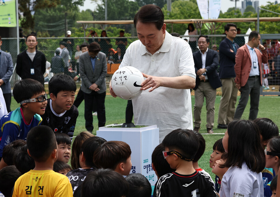 윤석열 대통령이 서울 용산 어린이정원 내 축구장에서 열린 김태영 대한축구협회 사회공헌위원장 주관으로 진행된 축구클리닉에서 축구공에 사인하고 있다. 윤운식 선임기자