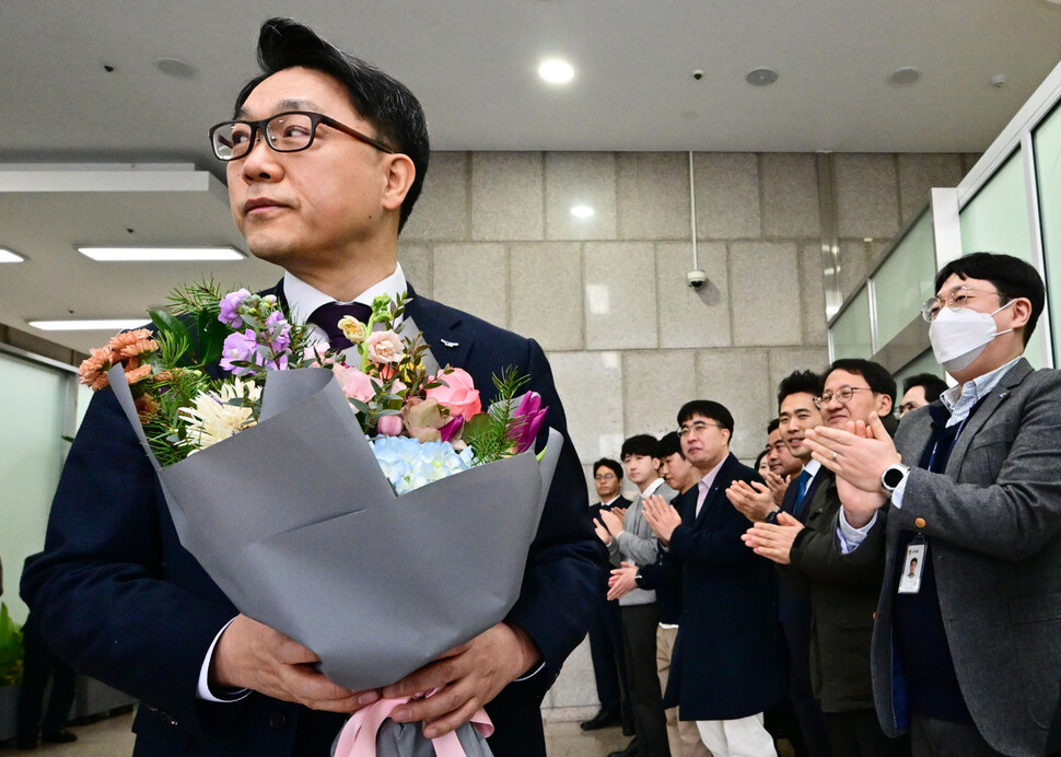 김진욱 고위공직자범죄수사처장이 19일 오전 정부과천청사 공수처에서 열린 이임식을 마친 뒤 건물을 나서며 직원들로부터 꽃다발을 받고 있다. 사진공동취재단