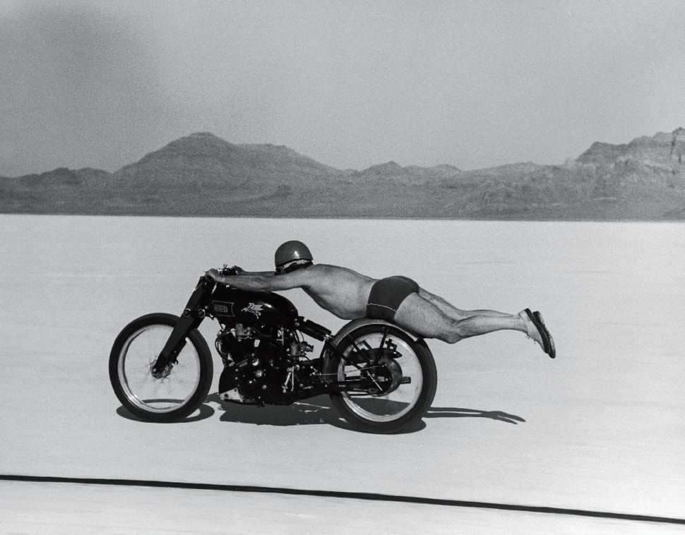 American motorcycle racer Roland Free (1900 - 1984) lies horizontally on his bike (to reduce wind resistance) as he brakes world's speed record in Bonneville Salt Flats, Utah, September 13, 1948. Photo by Peter S ⓒThe LIFE Picture Collection